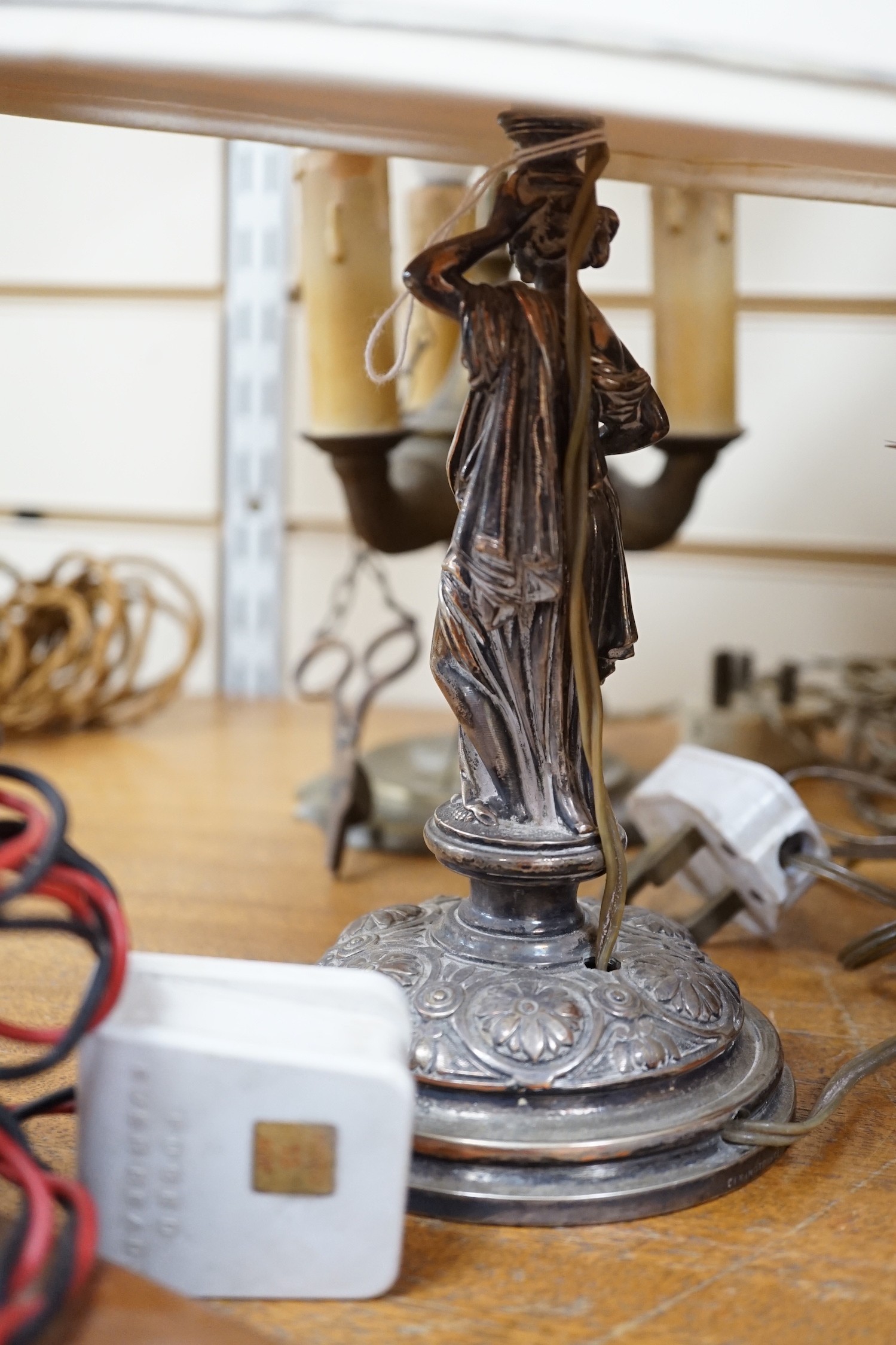 A Sheffield plated figural table lamp, a brass figural ‘Pierrot’ table lamp and An Eastern brass converted lamp with attached snuffer